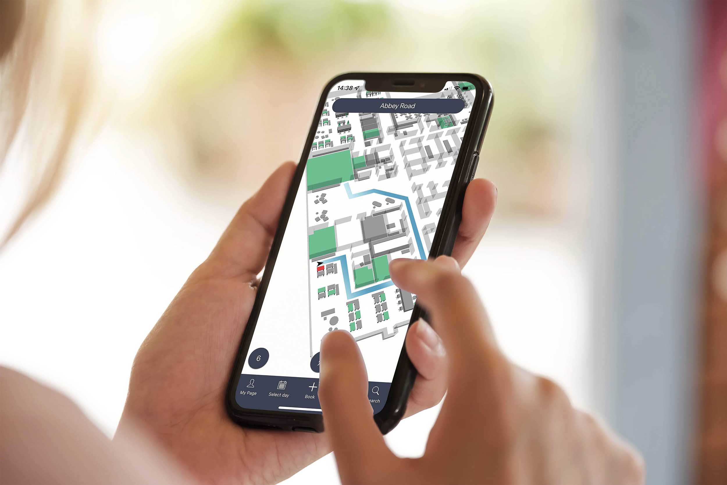 Woman using the Wayfinding app to easier find her way to the booked conference room in her office