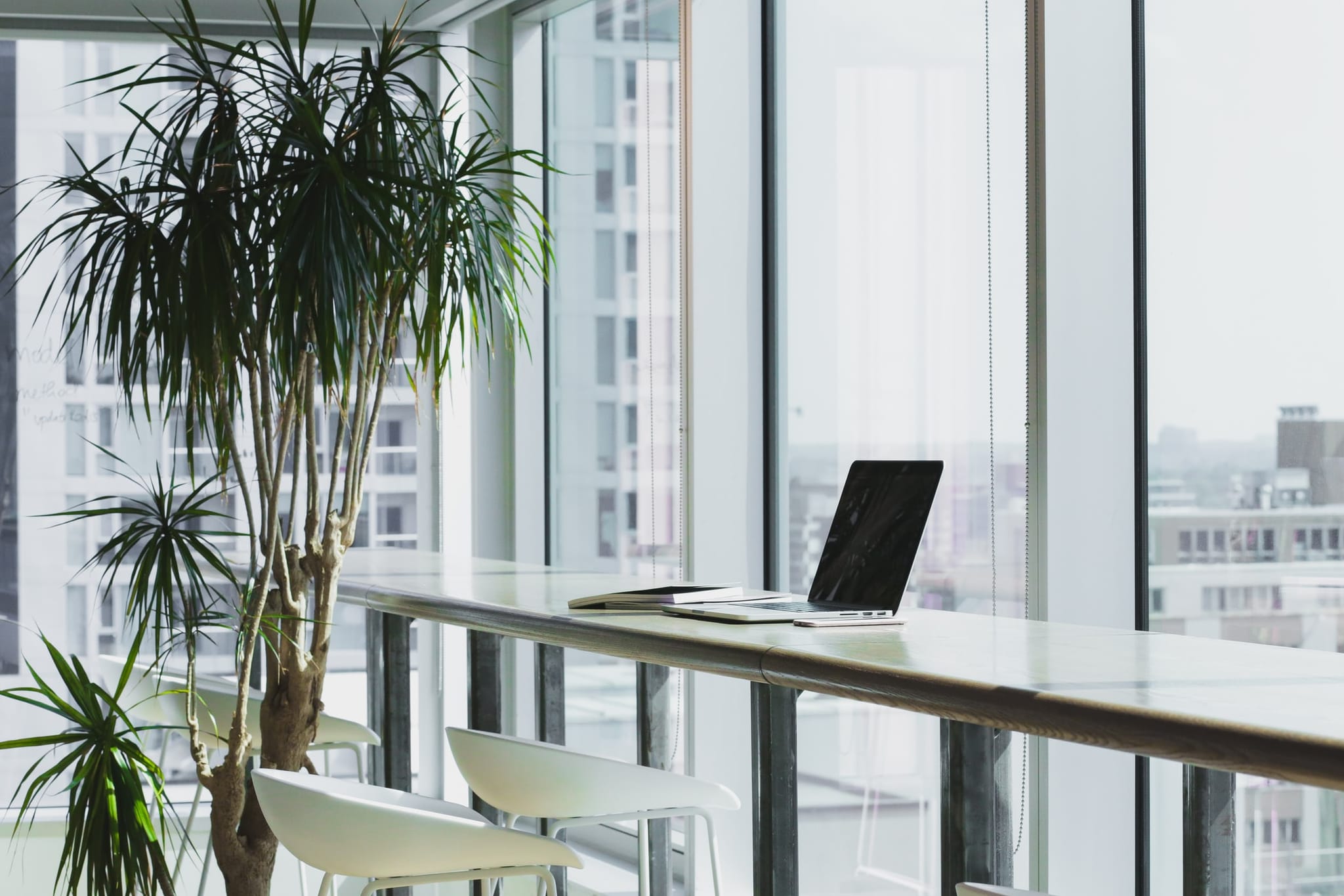 Picture of a vacant desk in an office environment with a laptop computer.