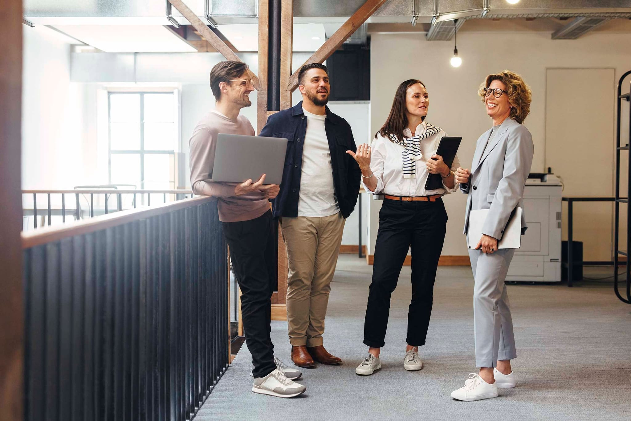 Colleagues standing on office floor